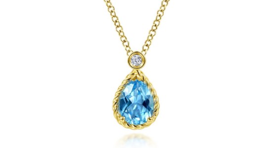 a yellow gold pendant necklace featuring an oval cut sky blue sapphire and diamond