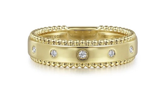 a yellow gold fashion ring with bezel set diamonds