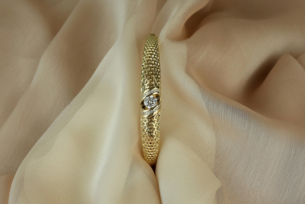 A close-up of a simple yet distinctive engagement ring nestled within beige taffeta.